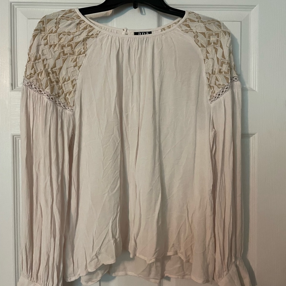 Ivory colored long sleeved with detailed shoulders.